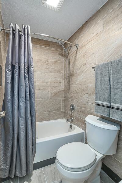 Private bathroom with tub and shower