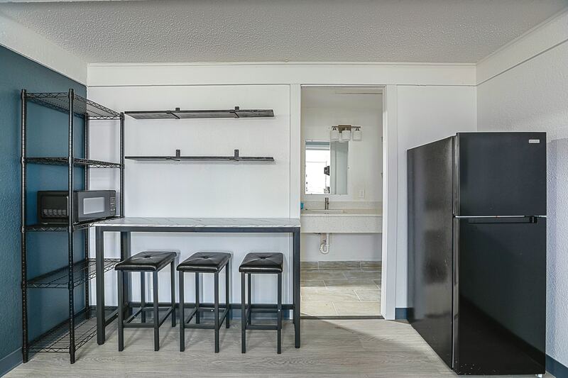 Kitchenette with microwave, refrigerator and breakfast bar